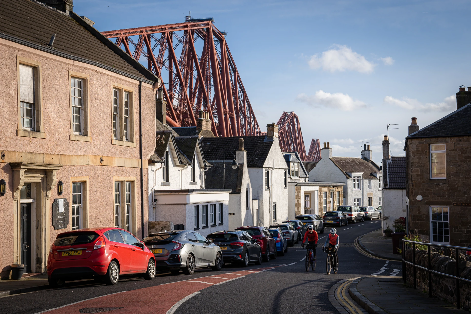 Background image - Cyclists in North Queensferry with View of Forth Bridge